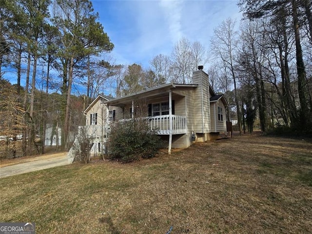 view of front of home with a porch and a front lawn