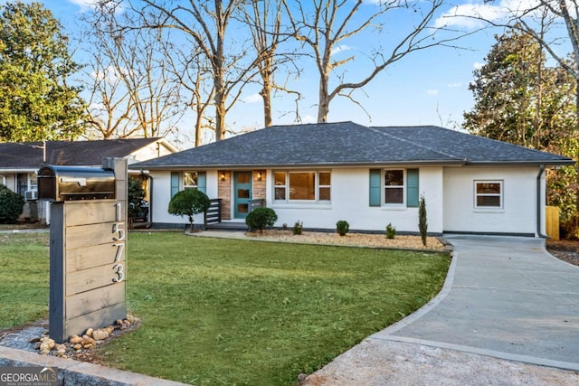 ranch-style home with a front lawn