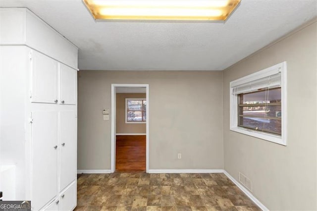 empty room featuring a textured ceiling