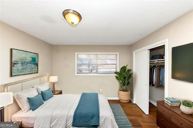 bedroom with dark hardwood / wood-style flooring and a closet