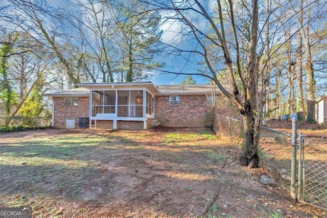 rear view of property with a sunroom