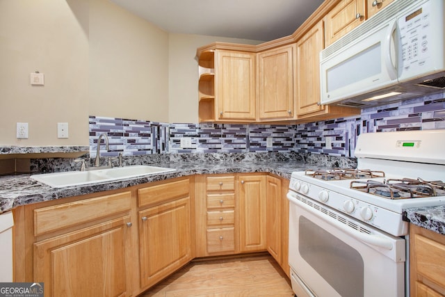 kitchen with light brown cabinetry, sink, backsplash, light hardwood / wood-style floors, and white appliances