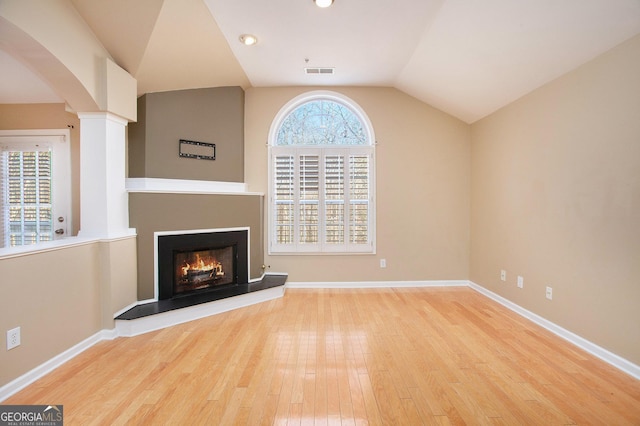 unfurnished living room with light hardwood / wood-style flooring and vaulted ceiling