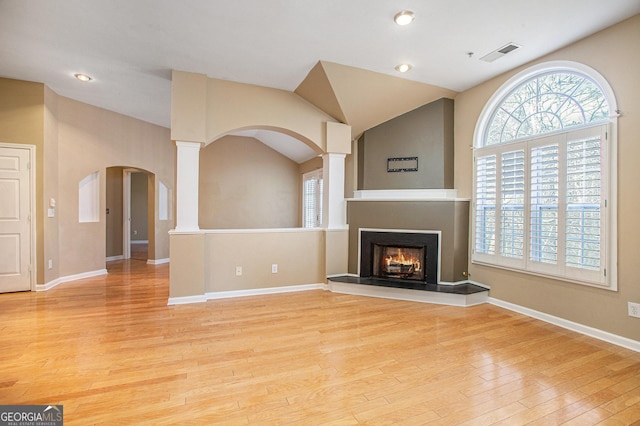 unfurnished living room featuring vaulted ceiling and light wood-type flooring