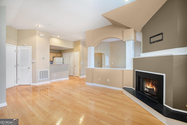 unfurnished living room featuring light wood-type flooring