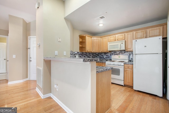 kitchen featuring tasteful backsplash, light wood-type flooring, white appliances, and kitchen peninsula