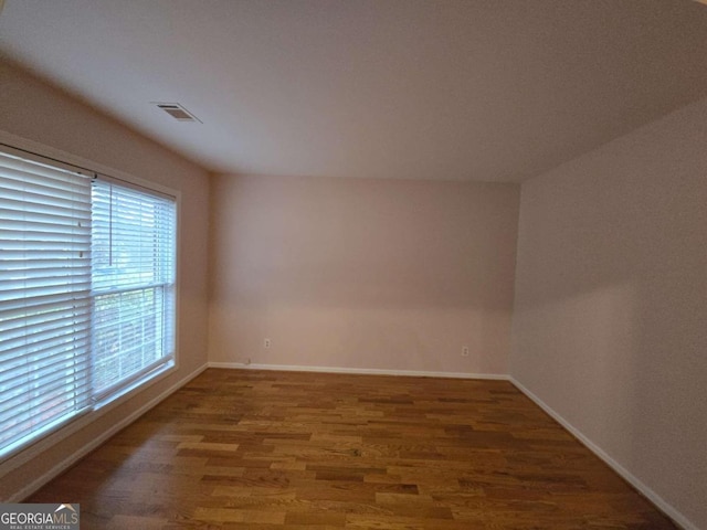 spare room featuring dark wood-type flooring