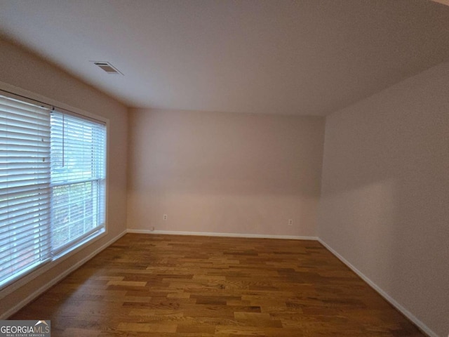 spare room featuring dark wood-type flooring