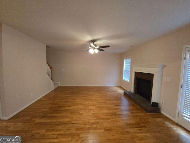 unfurnished living room with wood-type flooring and ceiling fan