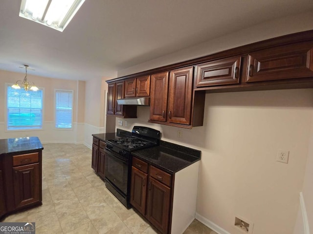 kitchen featuring a chandelier, hanging light fixtures, dark brown cabinets, dark stone countertops, and black gas stove