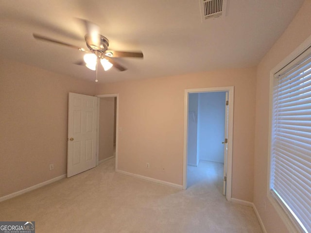 spare room featuring light carpet and ceiling fan