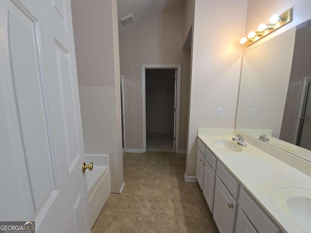 bathroom featuring vanity and a tub