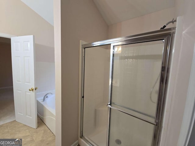 bathroom featuring tile patterned floors, lofted ceiling, and shower with separate bathtub