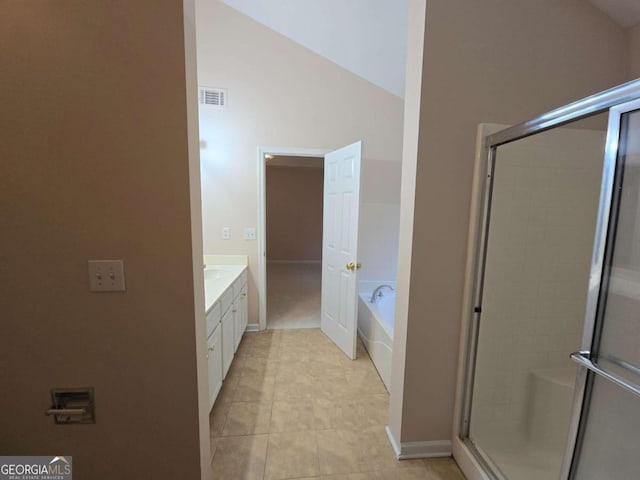 bathroom with vanity, tile patterned flooring, lofted ceiling, and plus walk in shower