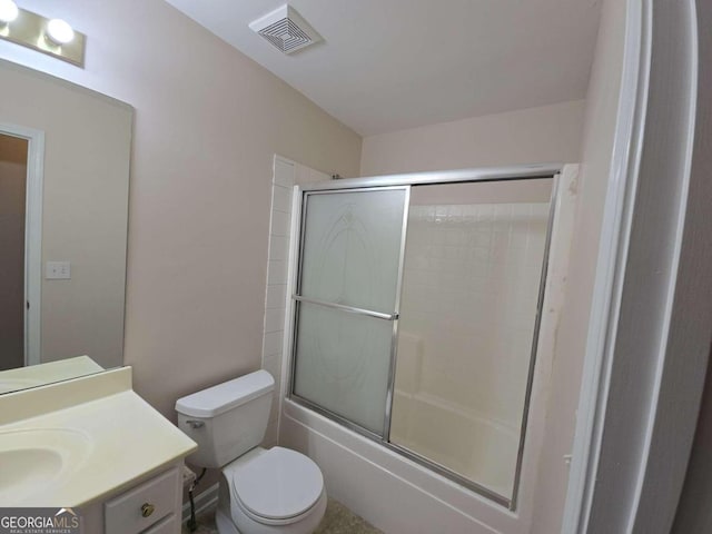 full bathroom with vanity, combined bath / shower with glass door, and toilet