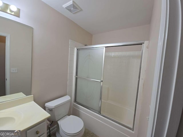 full bathroom featuring shower / bath combination with glass door, vanity, and toilet