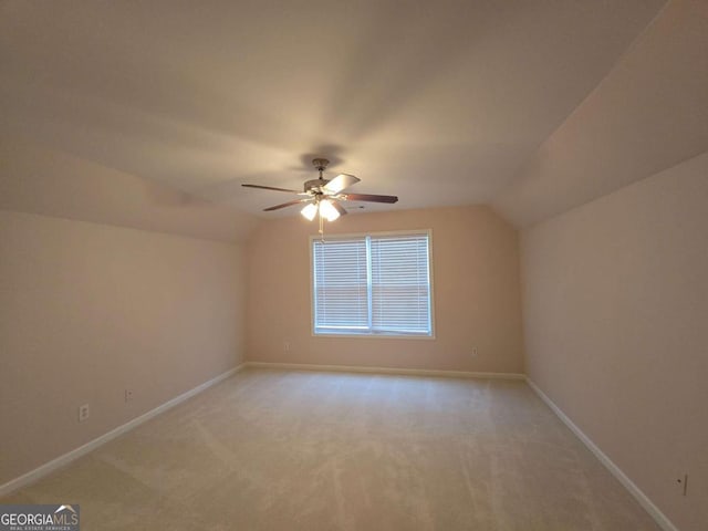 additional living space featuring lofted ceiling, light carpet, and ceiling fan