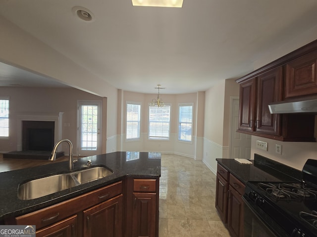 kitchen with pendant lighting, a healthy amount of sunlight, black range with gas cooktop, and sink