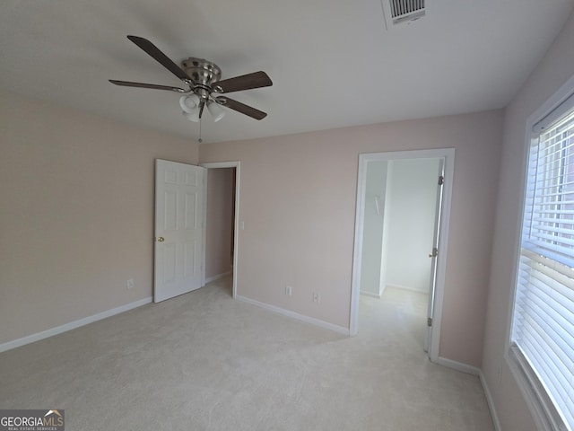 unfurnished bedroom with light colored carpet and ceiling fan