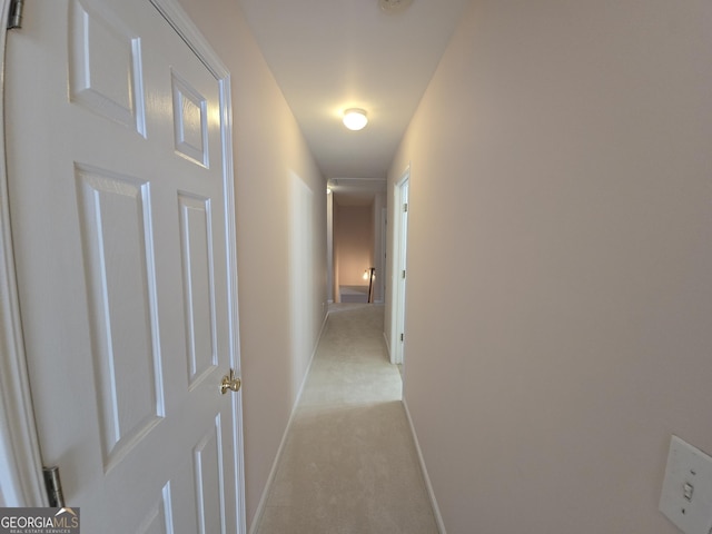 hallway featuring light carpet