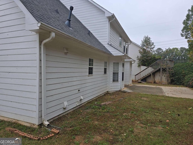 view of home's exterior with a yard and a patio