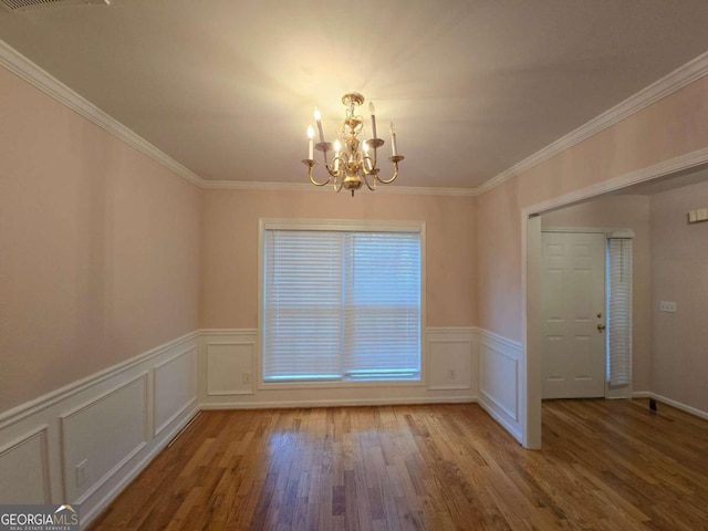 unfurnished dining area featuring crown molding, a chandelier, and light hardwood / wood-style floors