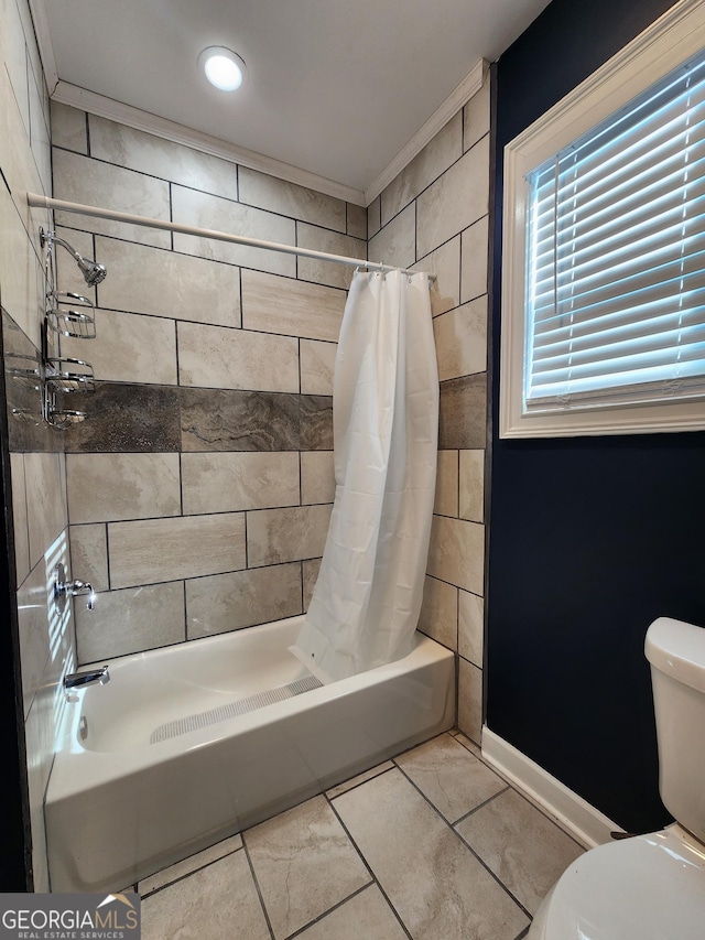 bathroom with tile patterned flooring, ornamental molding, shower / tub combo with curtain, and toilet