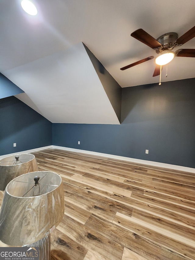 bonus room with vaulted ceiling, hardwood / wood-style floors, and ceiling fan