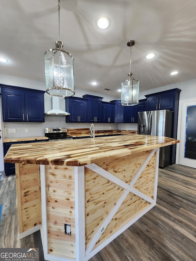 kitchen featuring wood counters, hanging light fixtures, blue cabinets, and appliances with stainless steel finishes