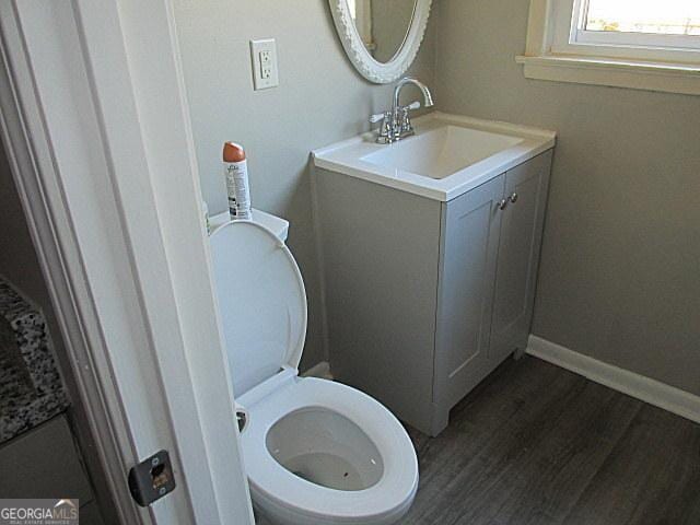 bathroom featuring hardwood / wood-style flooring, vanity, and toilet