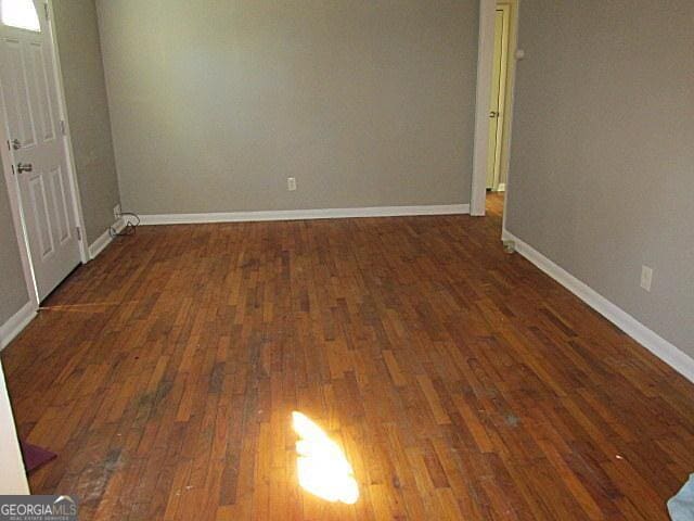 empty room featuring dark wood-type flooring