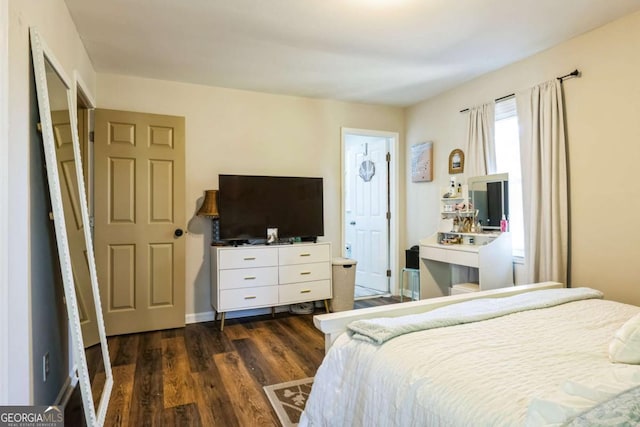 bedroom with dark hardwood / wood-style flooring