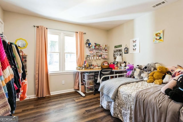 bedroom with dark wood-type flooring