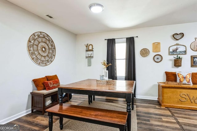 dining space with dark wood-type flooring