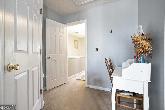 office area with carpet flooring and a textured ceiling