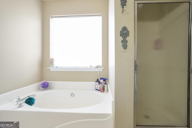 bathroom featuring independent shower and bath