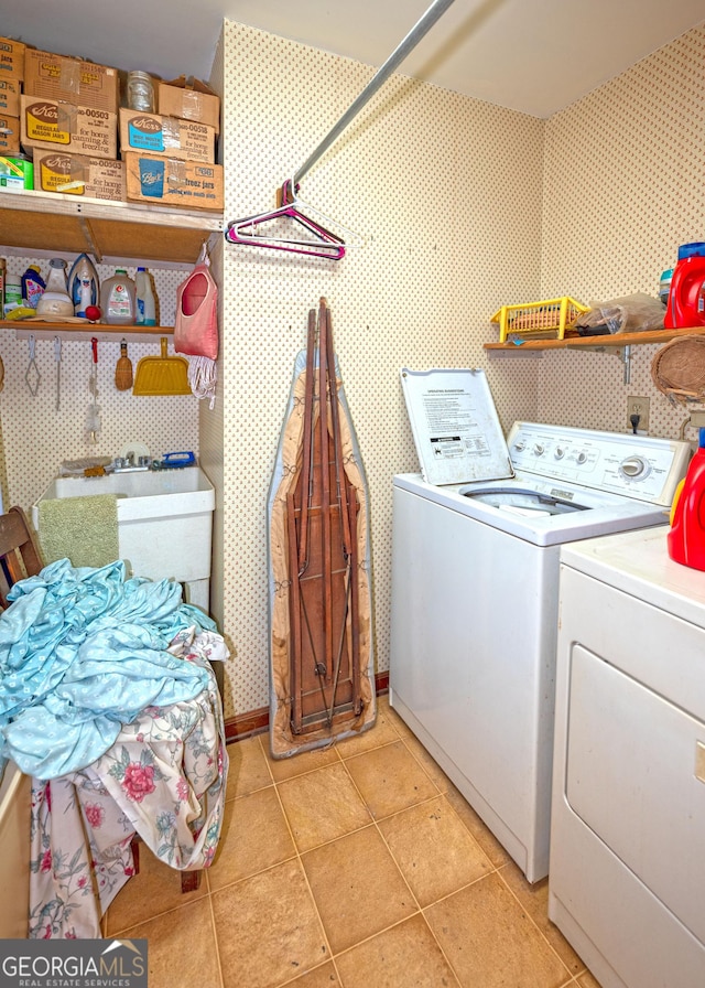 washroom with light tile patterned flooring and washing machine and dryer