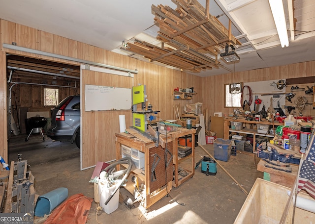 basement featuring wooden walls and a workshop area