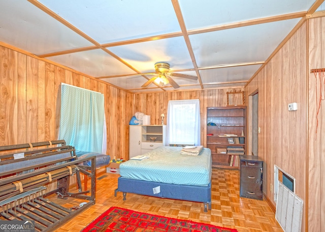 bedroom with parquet flooring, coffered ceiling, and wood walls