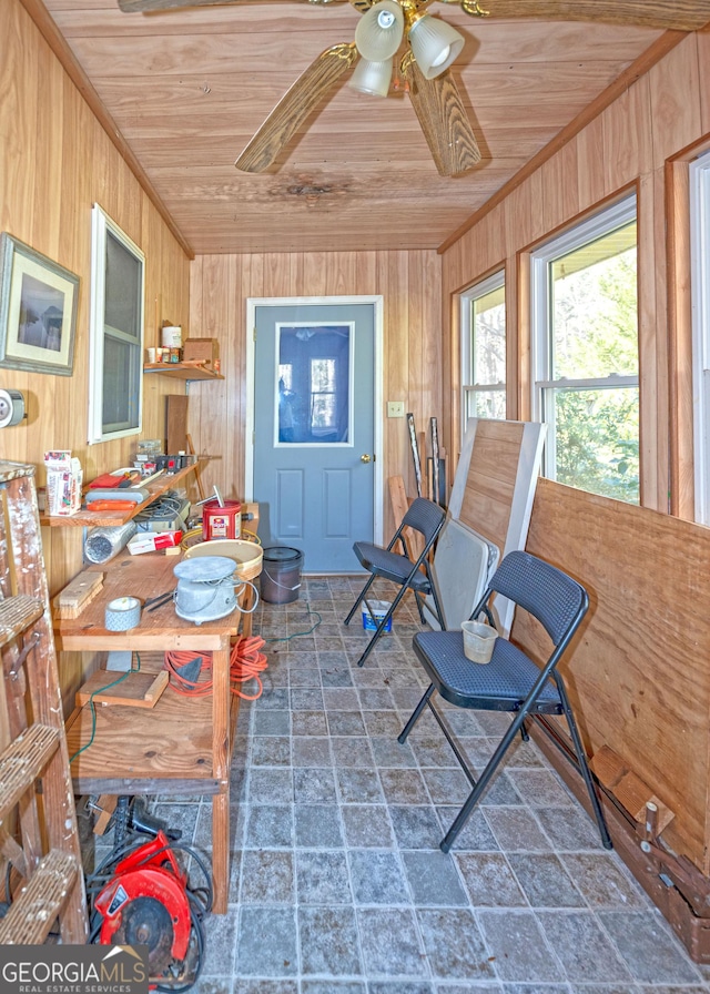 sunroom / solarium with wood ceiling and ceiling fan