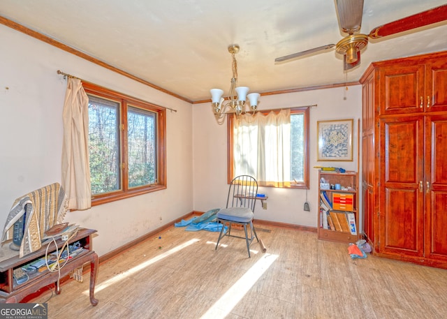 dining room with crown molding, light hardwood / wood-style flooring, and ceiling fan with notable chandelier