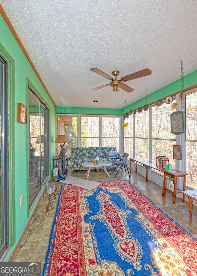 sunroom / solarium featuring ceiling fan