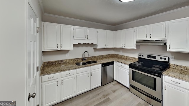 kitchen featuring stainless steel appliances, stone countertops, sink, and white cabinets