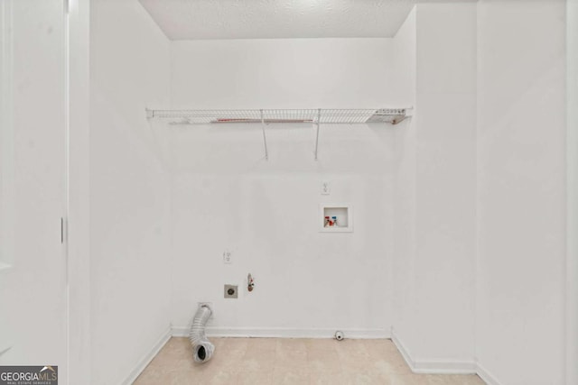 washroom with washer hookup, hookup for a gas dryer, hookup for an electric dryer, and a textured ceiling