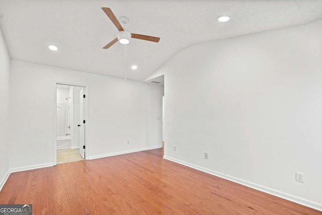 unfurnished room with lofted ceiling, wood-type flooring, and ceiling fan