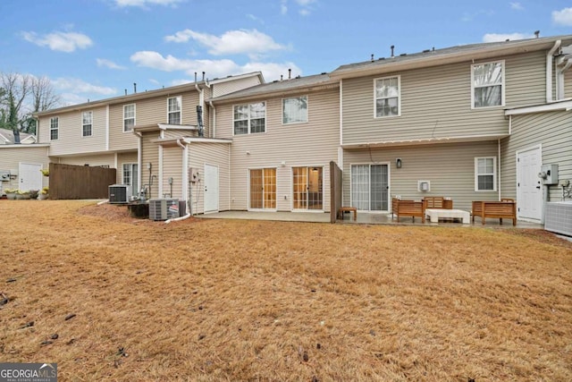 rear view of property with a patio, a yard, and central AC unit