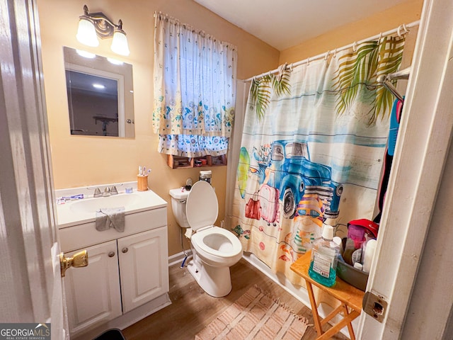 bathroom featuring vanity, hardwood / wood-style floors, toilet, and walk in shower