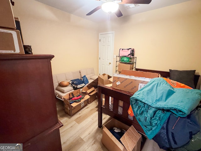 bedroom with light hardwood / wood-style flooring and ceiling fan