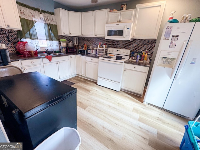 kitchen featuring tasteful backsplash, white appliances, white cabinetry, and light wood-type flooring