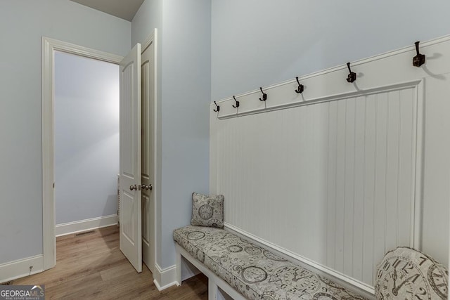 mudroom with wood finished floors and baseboards